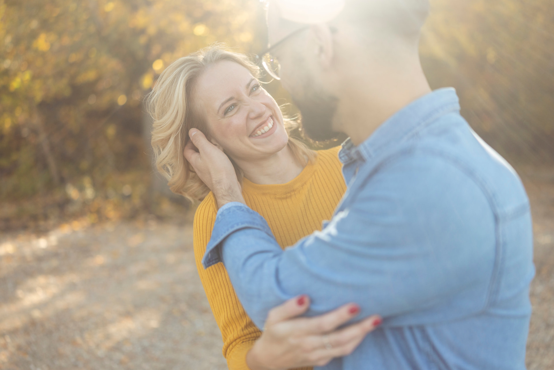 Couple laughing together outdoors in warm afternoon light